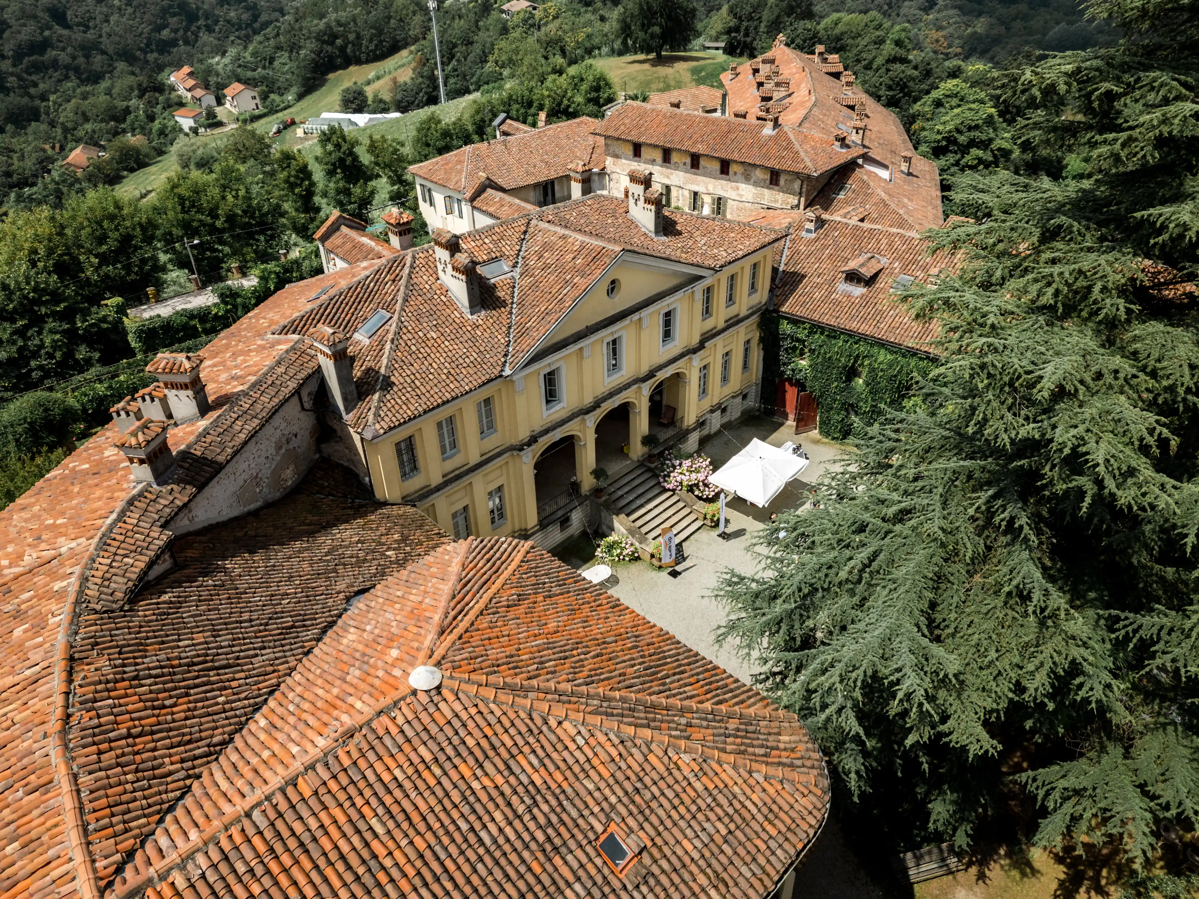 Drone view of the historic castle complex with Alps in the background